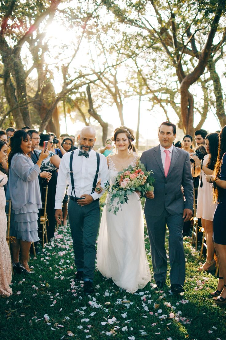 a bride and groom walking down the aisle