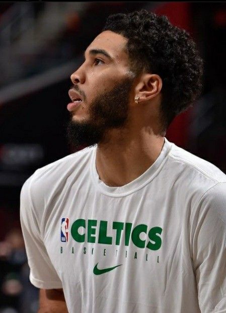 a close up of a basketball player wearing a white shirt with the word celtics on it