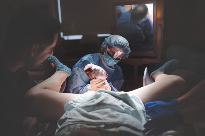 three doctors performing surgery on a patient in a hospital