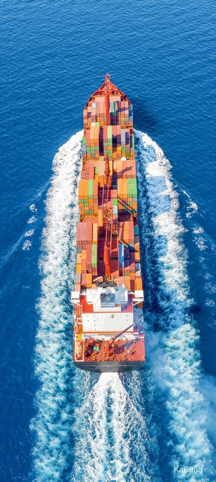 an aerial view of a large container ship in the ocean