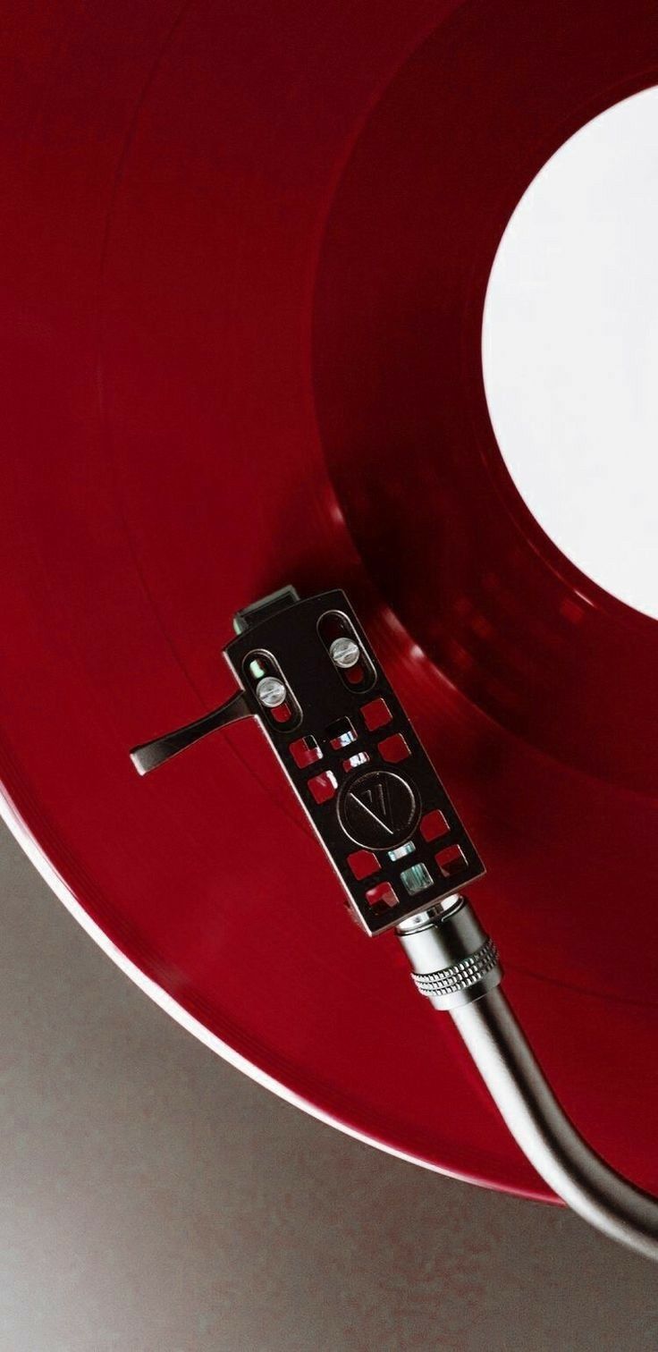 a close up of a red record player