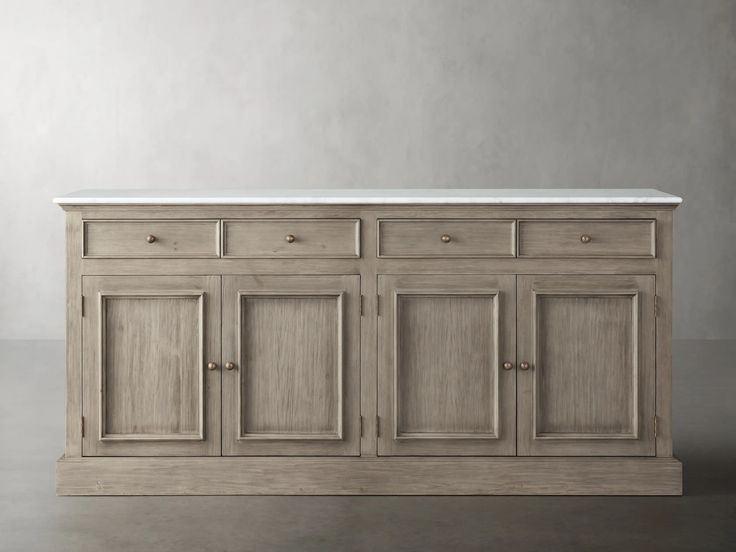 a large wooden cabinet with white marble top