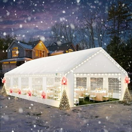 a large white tent with christmas lights on it