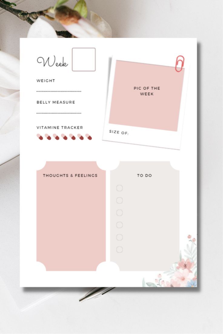 a pink and white planner sticker with flowers in the background on top of a table