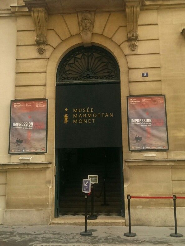 an entrance to the museum of mormon in new york city, with posters on the wall