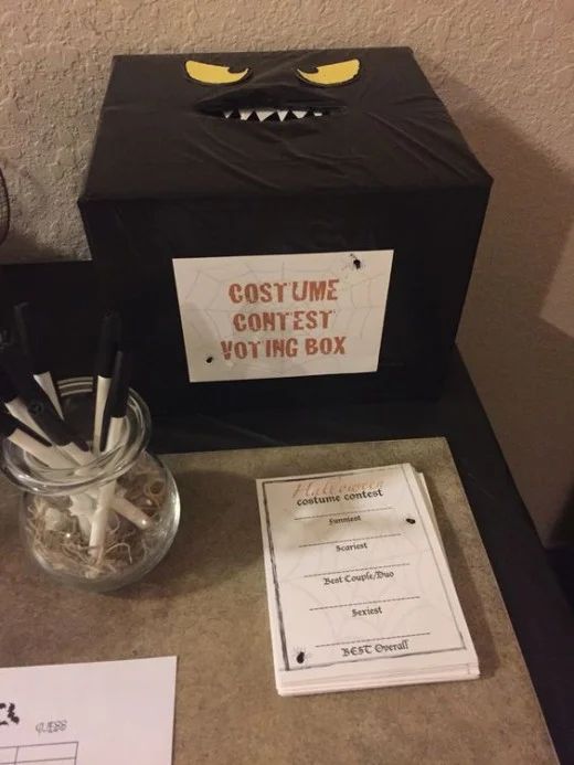 a box with toothbrushes in it sitting on a counter next to a sign that says costume contest contest