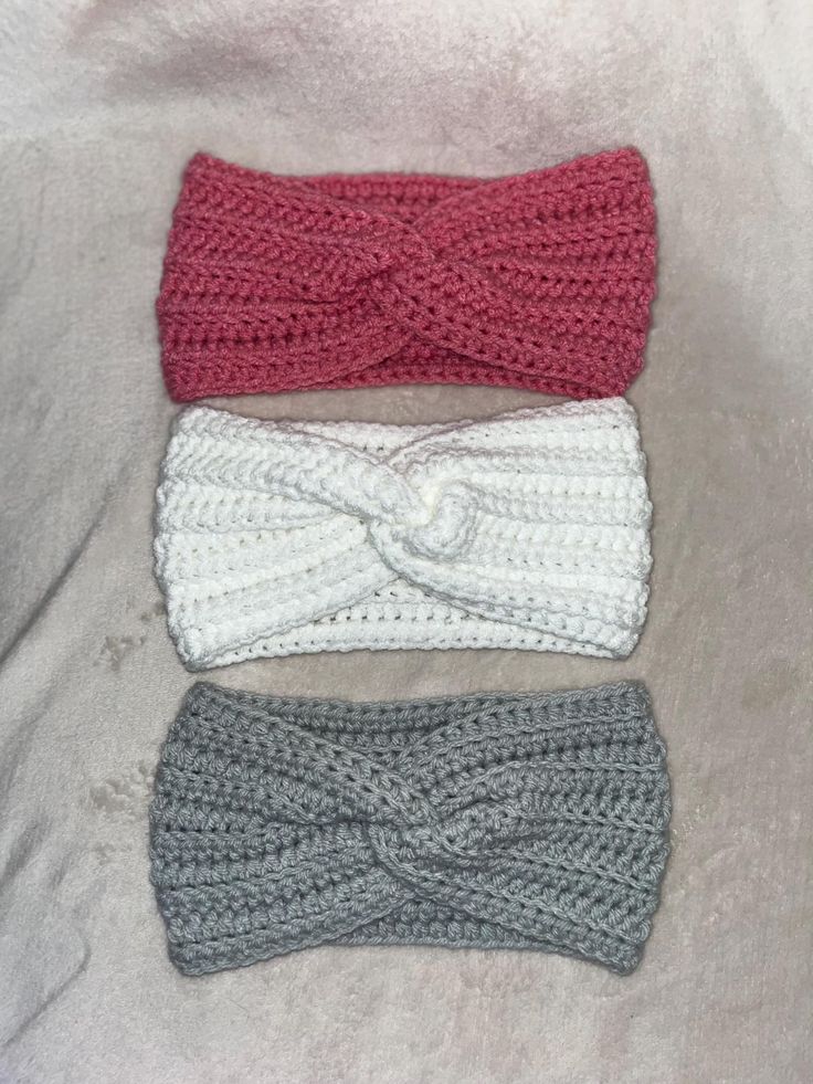 three crocheted headbands on top of each other, one with a knot