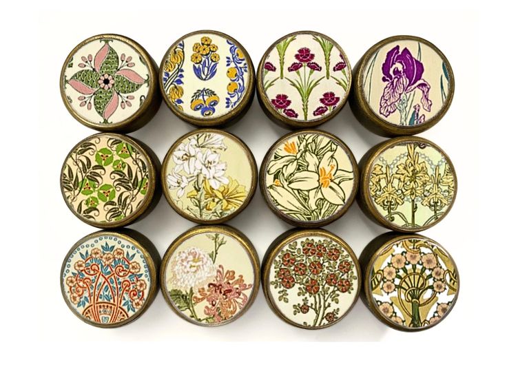 nine different types of flowers painted on small magnets in various colors and sizes, all with floral designs