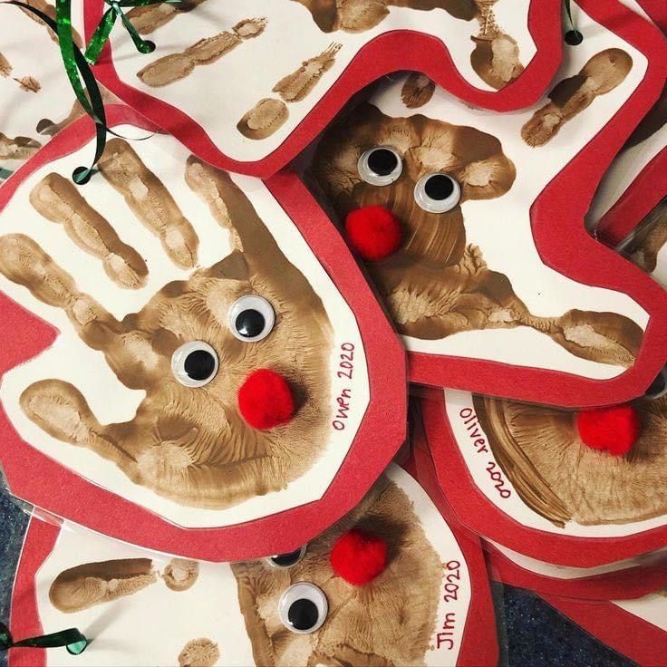 several handprinted christmas ornaments with red noses