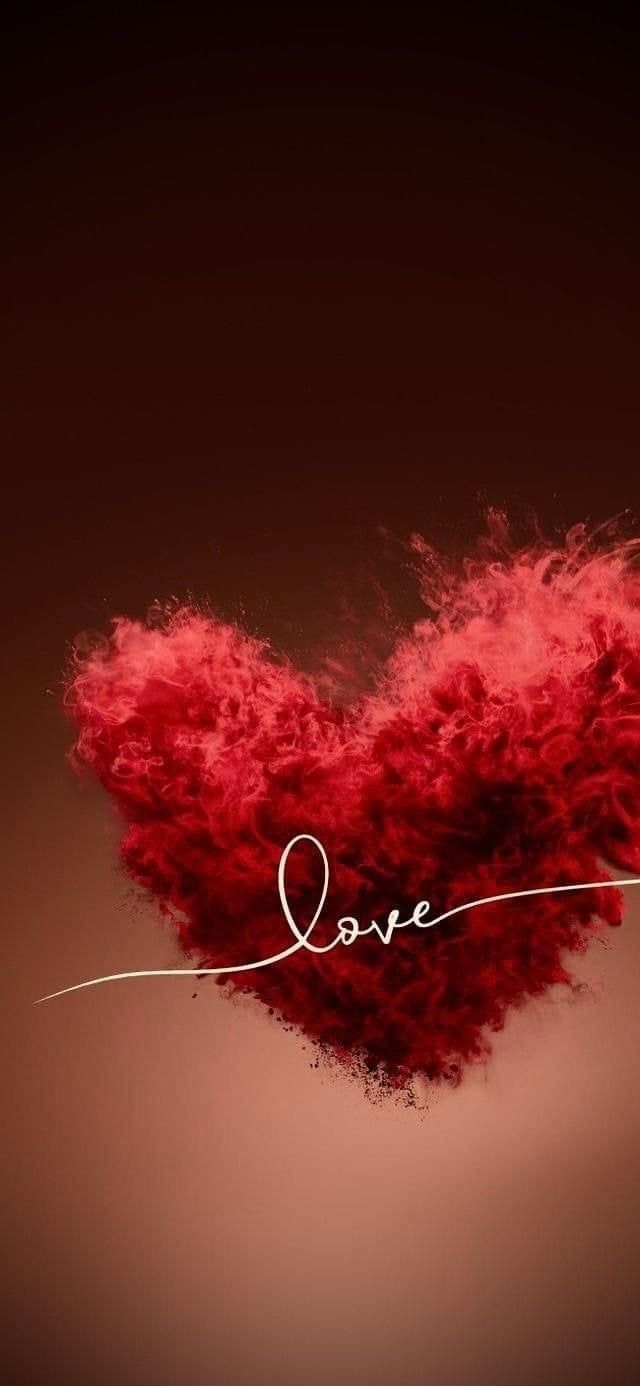 the word love is written on top of a red fluffy heart shaped object that appears to be floating in the air