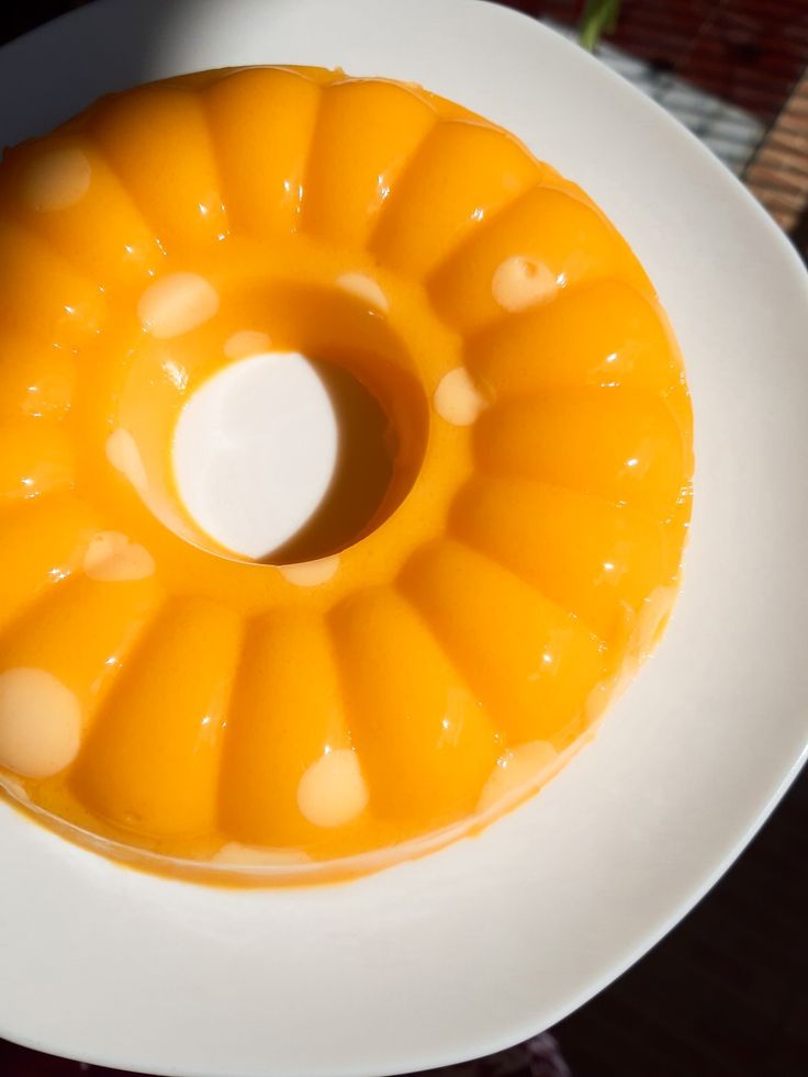 an orange bundt cake on a white plate