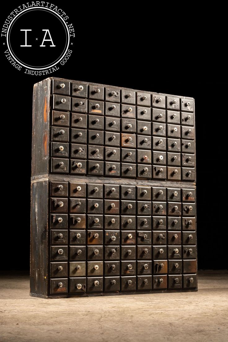 two large metal boxes stacked on top of each other in front of a black background