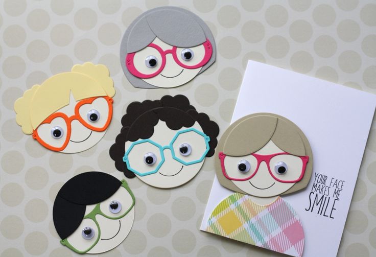 the paper dolls are wearing glasses and smiling