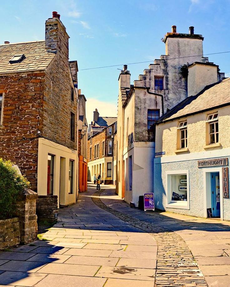 an old cobblestone street lined with stone buildings