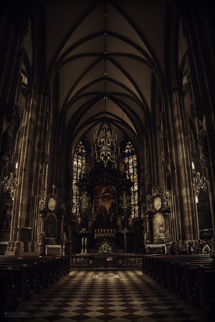 the inside of a church with stained glass windows and pews on either side of the alter