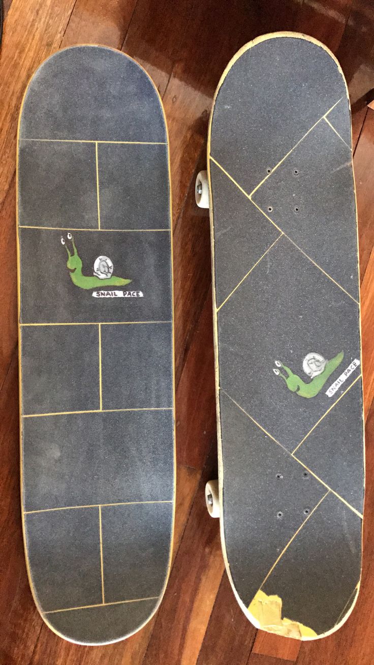 two skateboards sitting on top of a wooden floor