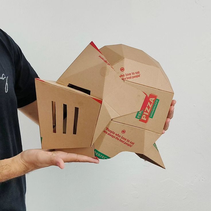 a man holding an open pizza box in one hand and a closed pizza box in the other