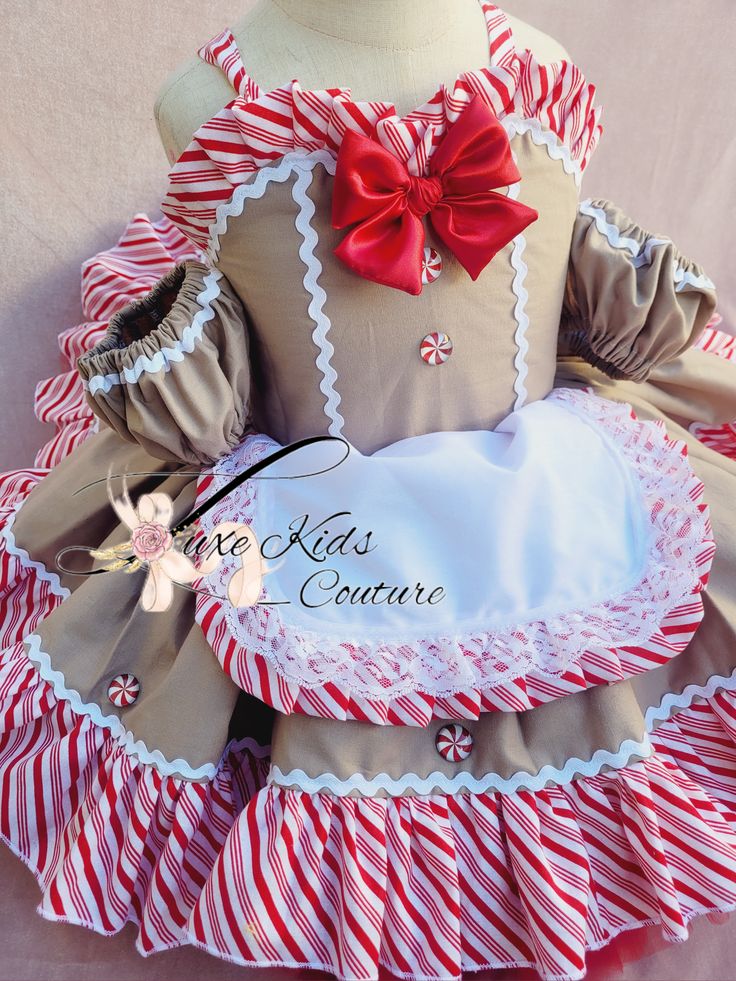 a dress made to look like a doll with red and white striped ruffles