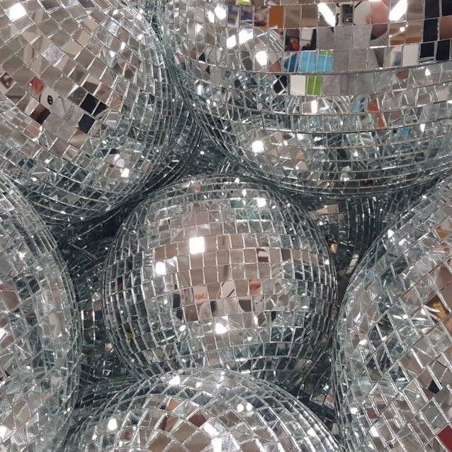 many shiny disco balls are stacked together