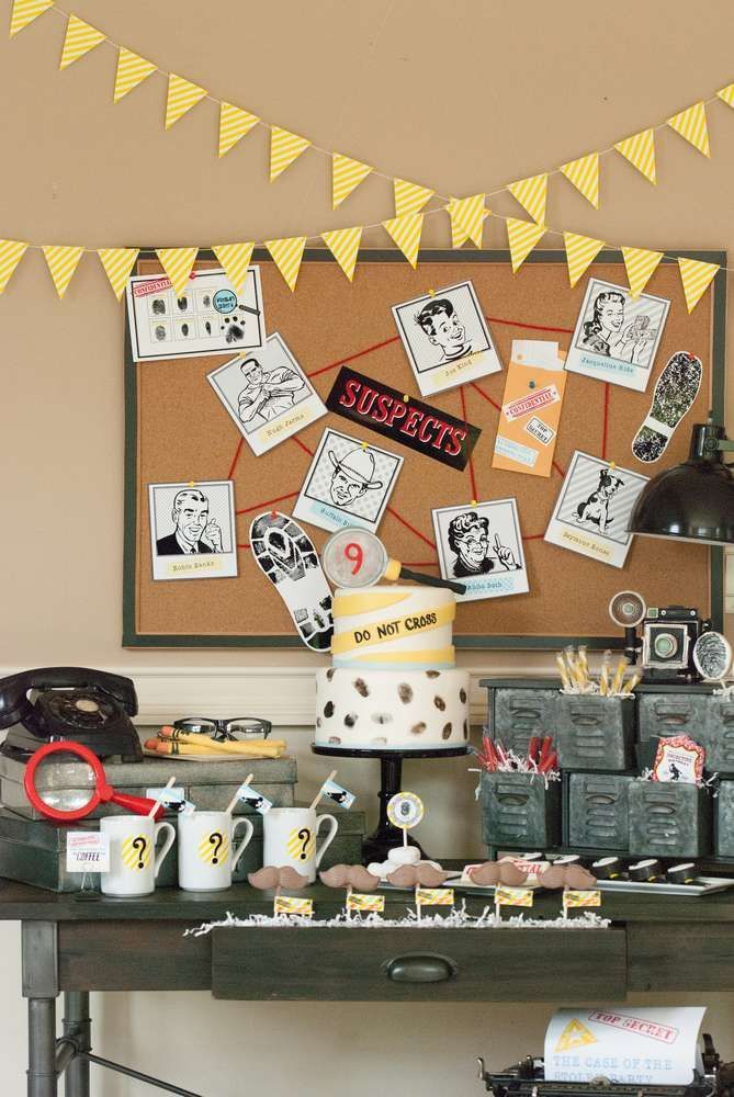 a table topped with lots of cupcakes next to a wall covered in pictures