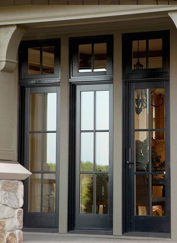 the front entrance to a house with double doors