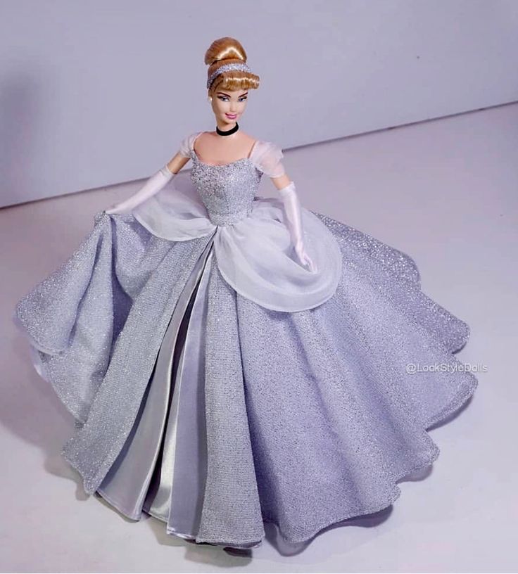 a barbie doll wearing a purple and silver dress