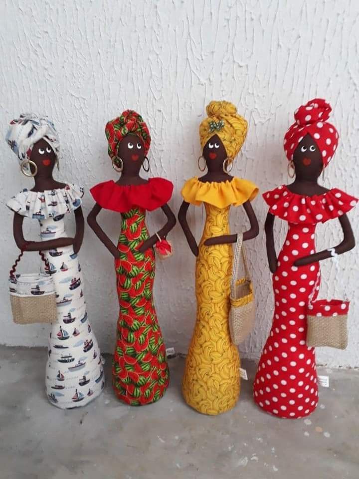 three african dolls are standing next to each other in dresses and headgear with polka dots on them