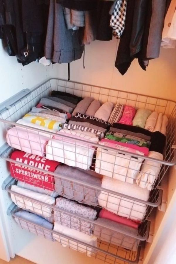 the closet is organized with clothes and other items for storage, including t - shirts