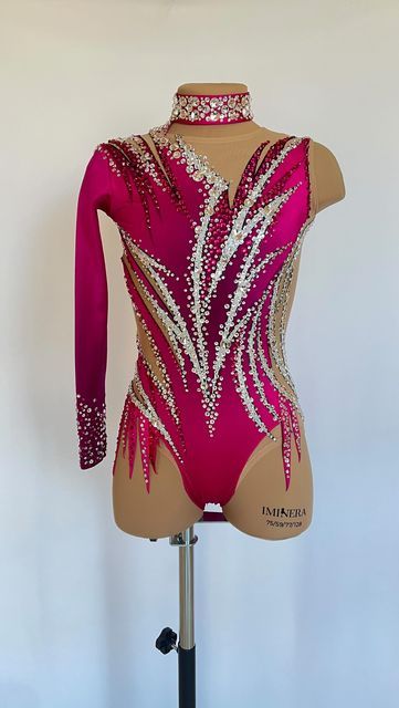 a female figure in a pink leotard with sequins