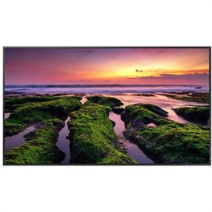 an image of the ocean at sunset with moss growing on rocks and water in the foreground