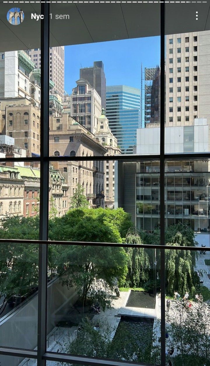 the view from inside an office building looking out onto a park and cityscape