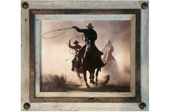 a painting of cowboys riding horses in the dust