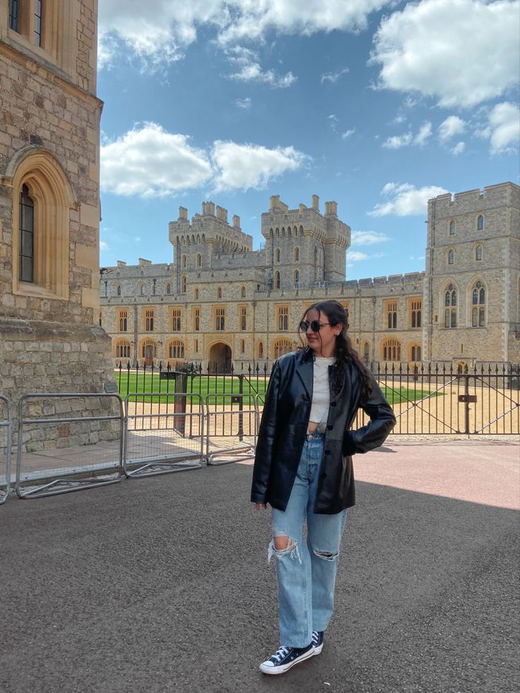 a woman standing in front of a castle