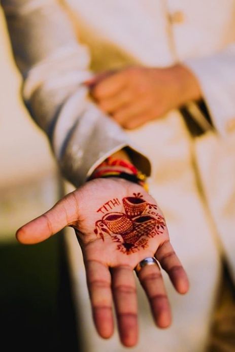 a person's hand with a tattoo on it and the palm of their left hand