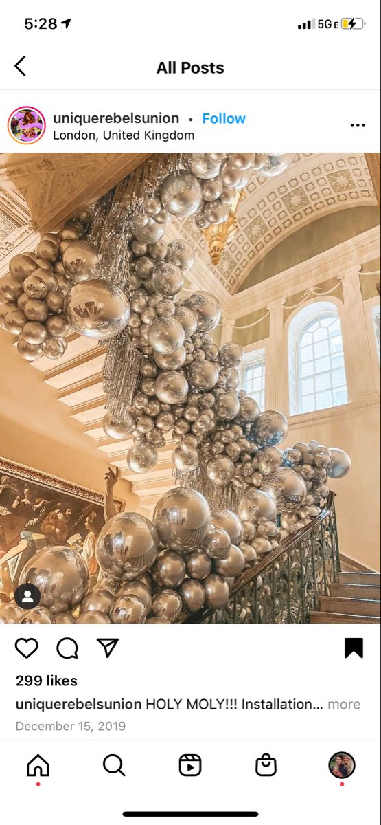 an instagram page with chrome balls hanging from it's ceiling and the caption below