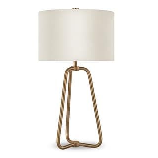 a table lamp with a white shade on the top and an iron frame around it