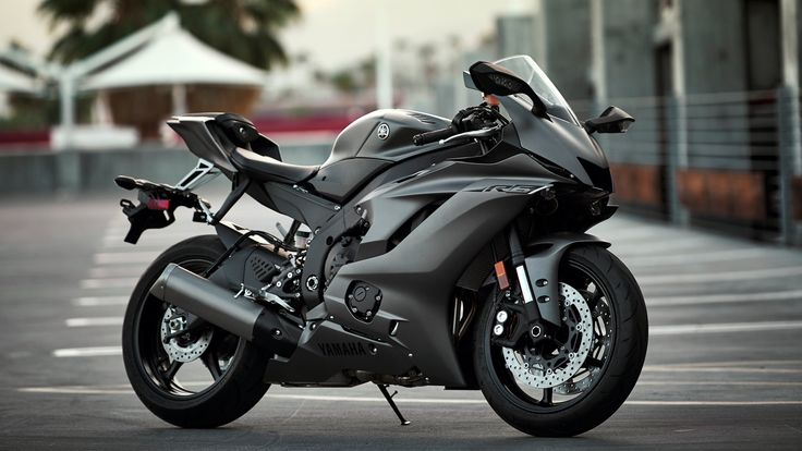 a black motorcycle parked in a parking lot