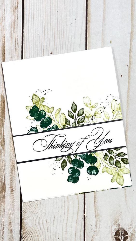 a white card with green leaves on it