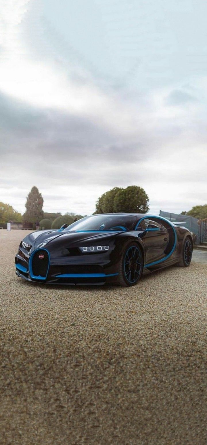 a black and blue bugatti is parked on the street