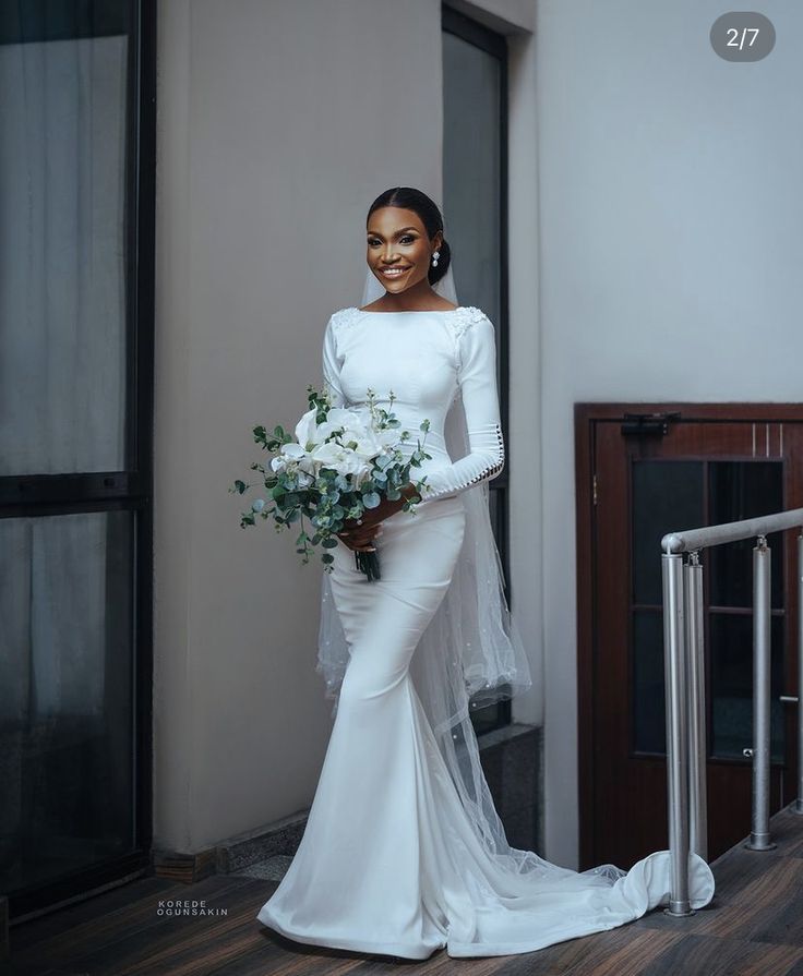 a woman in a white wedding dress holding a bouquet