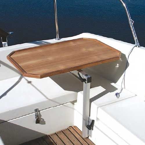 a wooden table on the deck of a boat