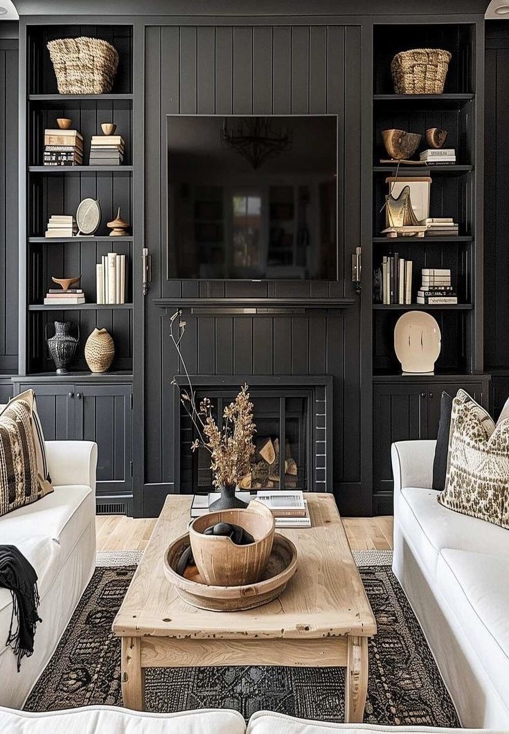 a living room filled with furniture and a flat screen tv mounted on a wall above a fire place