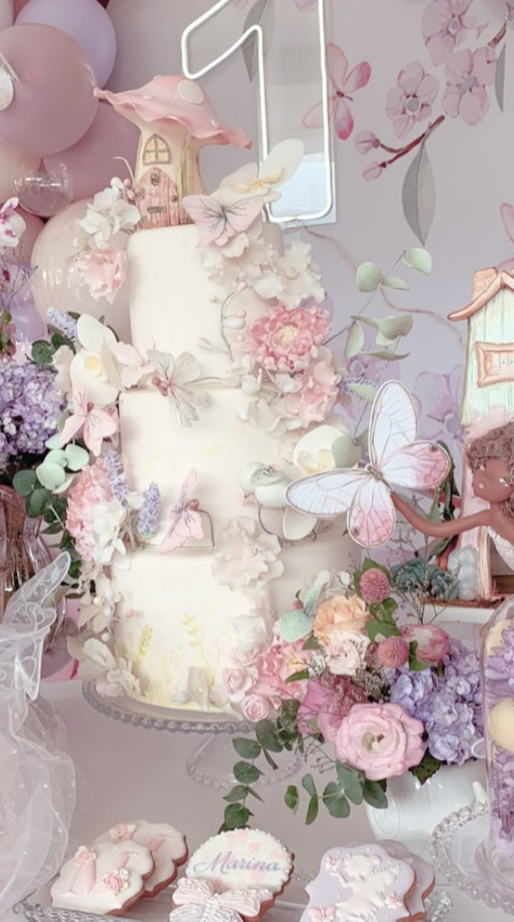 there is a wedding cake and cupcakes on the table