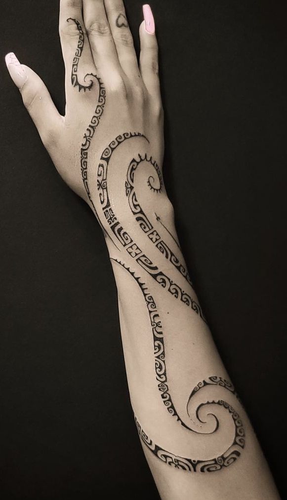 a woman's arm with an intricate tattoo on it