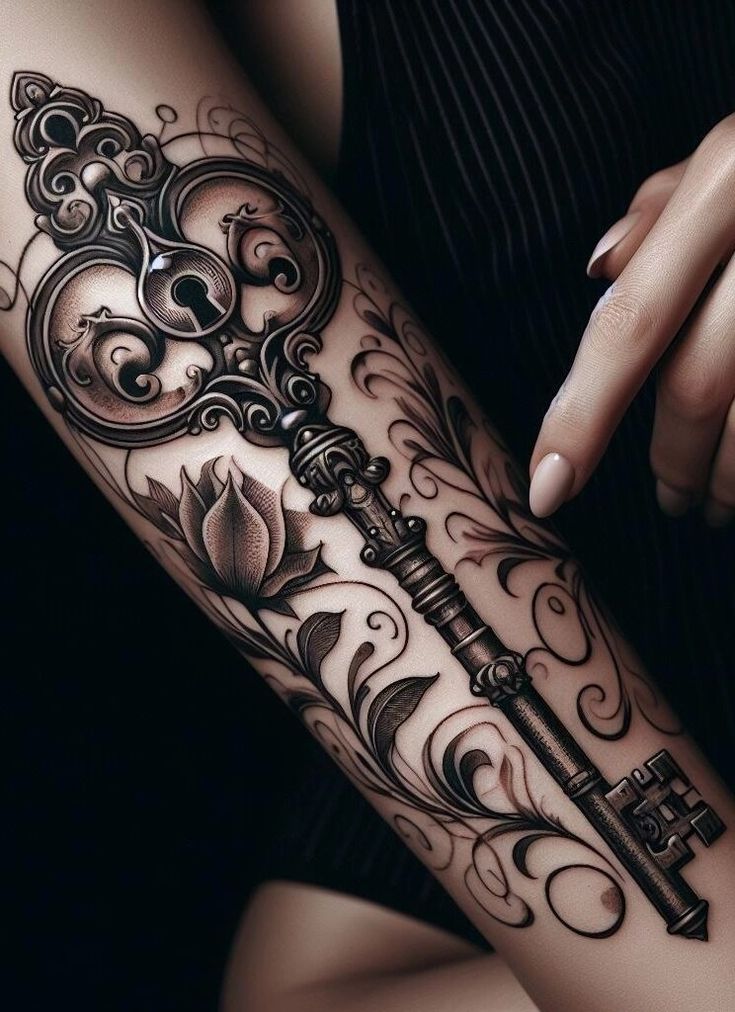 a woman's arm with a key tattoo on it