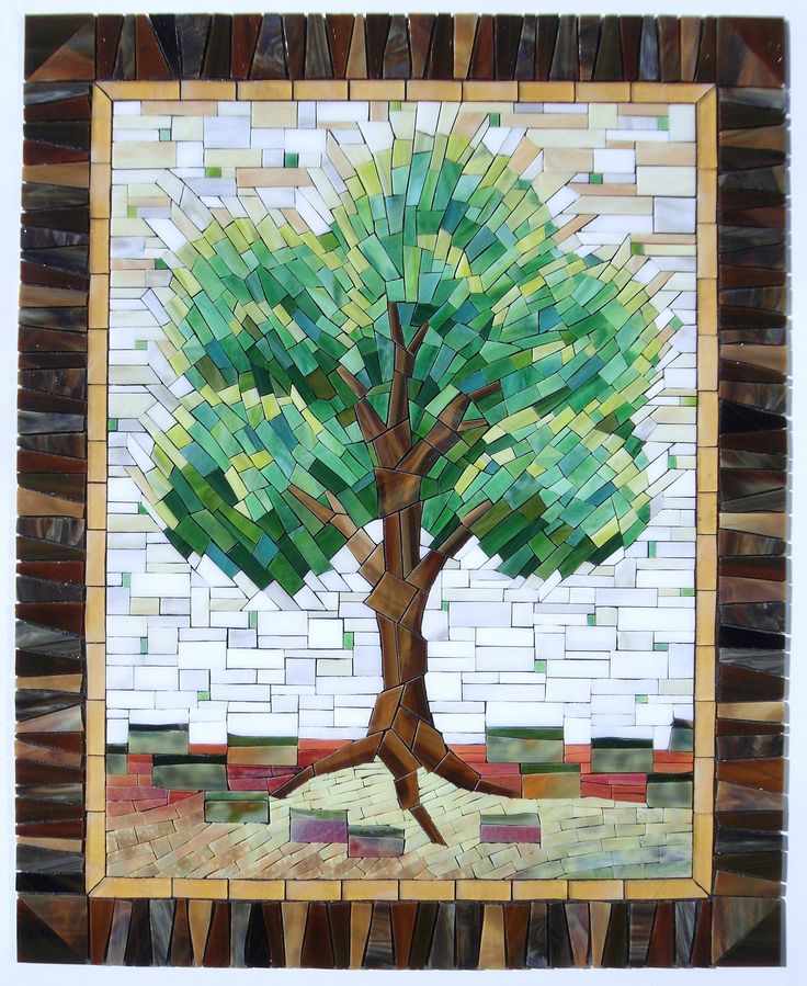 a mosaic tree with green leaves on it