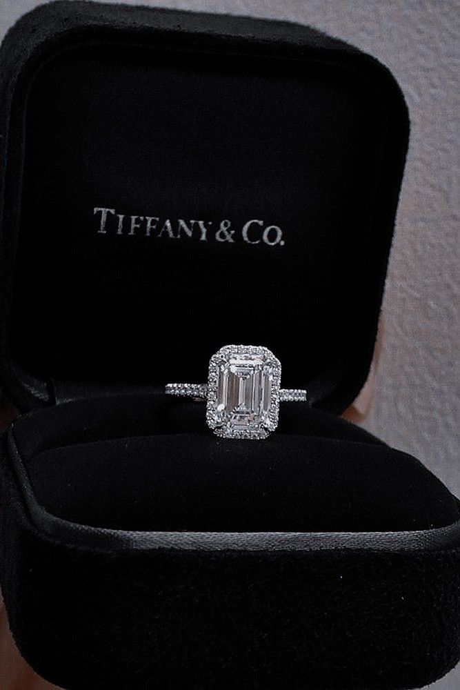 an engagement ring in a black box with the word tiffany & co on it's side