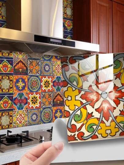 a hand holding up a piece of paper in front of a colorful tile backsplash