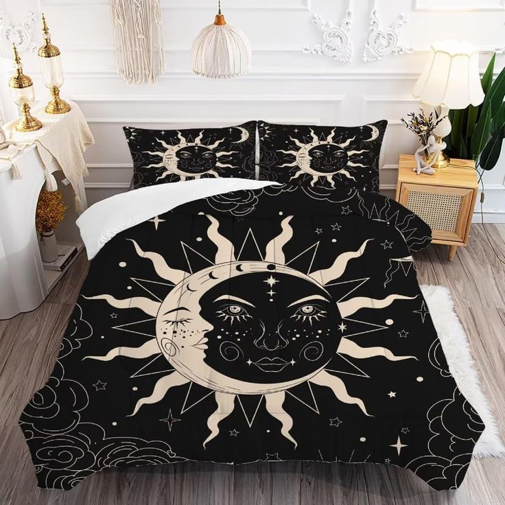 a black and white bed with sun and moon on it