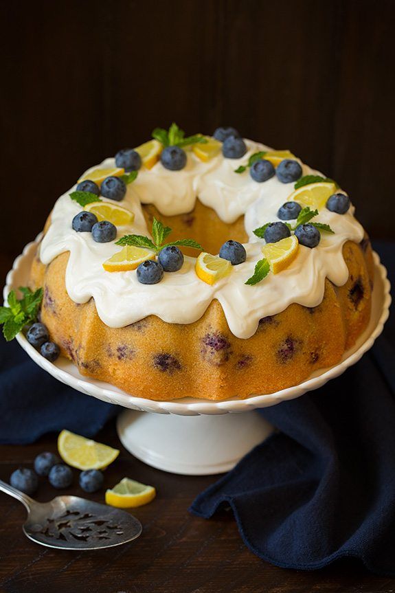 a cake with lemons and blueberries on top